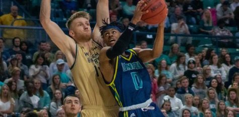 Ty Gadsden (0) attempts to shoot against a defender during UNCW's homecoming matchup against William & Mary on Feb. 8, 2020 at Trask Coliseum.