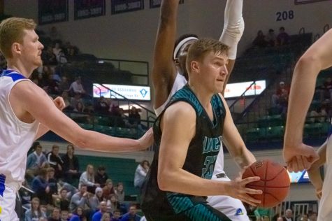 Marten Linssen battles Delaware defenders during UNCW's matchup with the Blue Hens on Feb. 29, 2020 at Trask Coliseum.