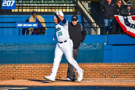 Ron Evans (25) crosses home plate during UNCW's Opening Day matchup with Dayton on Feb. 14, 2020 at Brooks Field