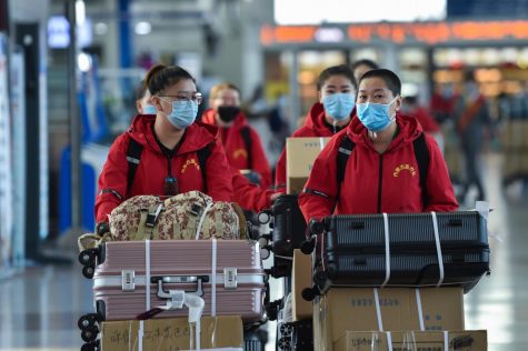 Medical team members prepare to check in at Hohhot Baita International Airport before leaving for Hubei Province in Hohhot, capital of north China's Inner Mongolia Autonomous Region, on Tuesday, Feb. 18, 2020. The seventh batch of medical workers from Inner Mongolia Autonomous Region to Hubei Province departed Tuesday to help the novel coronavirus control efforts there. (Liu Lei/Xinhua/Zuma Press/TNS)