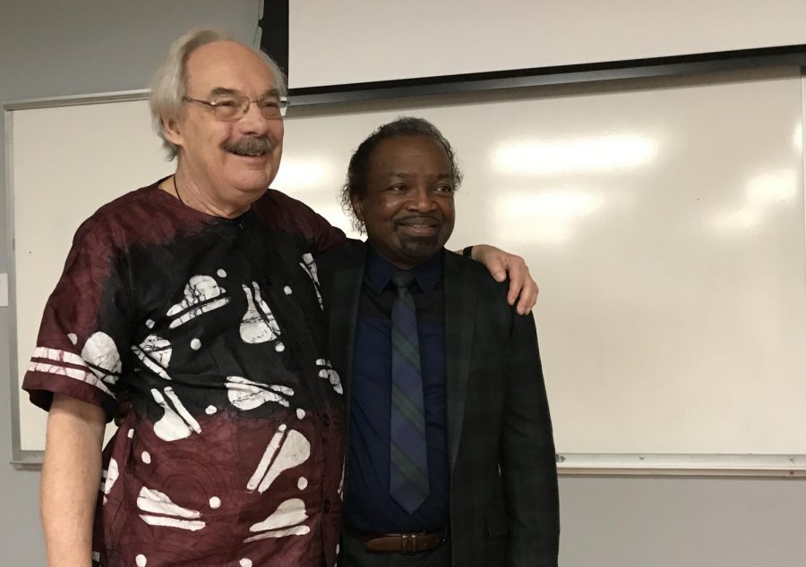 Dr. Paul E. Lovejoy (left) and Dr. Booksie S. Harrington (right) -- both members of the Harriet Tubman Institute at York University -- embrace each other onstage after Lovejoy’s presentation “Slavery in the Global Diaspora of Africa” the evening of March 5 at UNCW’s Randall Library.
