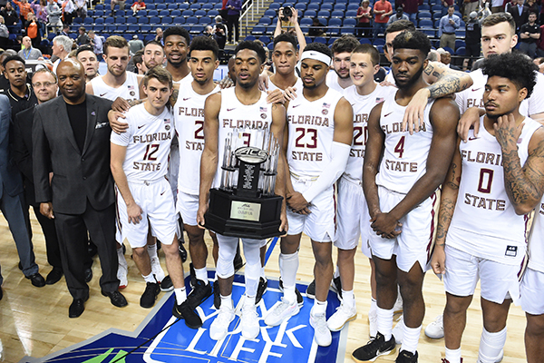 The Florida State basketball team hold the trophy as ACC Champions March 12, 2020. The tournament in Greensboro N.C.was canceled because of the coronavirus pandemic