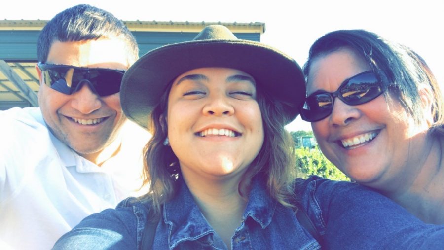 Writer Alejandra Rodriguez-Aguero (center) with her father, Gerardo Rodriguez, and mother, Alma Aguero, at a pumpkin patch.