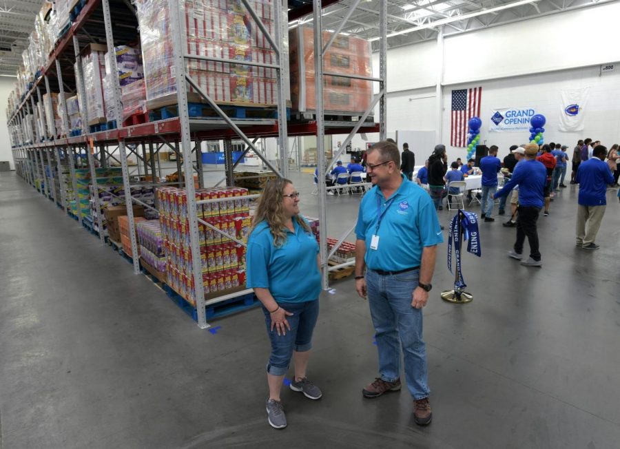 Assistant general manager Kathy Hartman, left, and general manager Bob King chat in the warehouse where Sams Club orders will be filled. The Sams Club fulfillment center held a ribbon-cutting ceremony Thursday on Tobias Boland Way. [T&G Staff/Christine Peterson]
