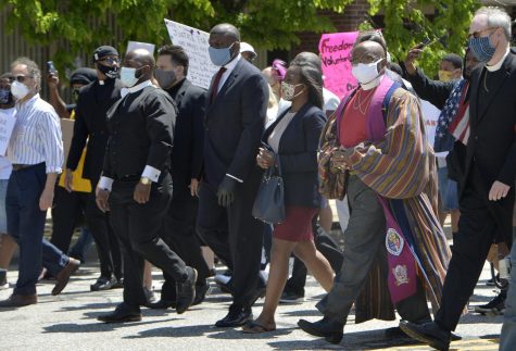 Community leaders and clergy members march north on State Street on June 6, 2020, in Erie. More than 2,000 people marched from 11th and State streets to Perry Square to protest the killing of George Floyd on Memorial Day in Minneapolis. ([GREG WOHLFORD/ERIE TIMES-NEWS)