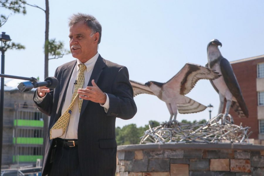 UNCW's Chancellor Jose V. Sartarelli in front of the new sculpture. 
