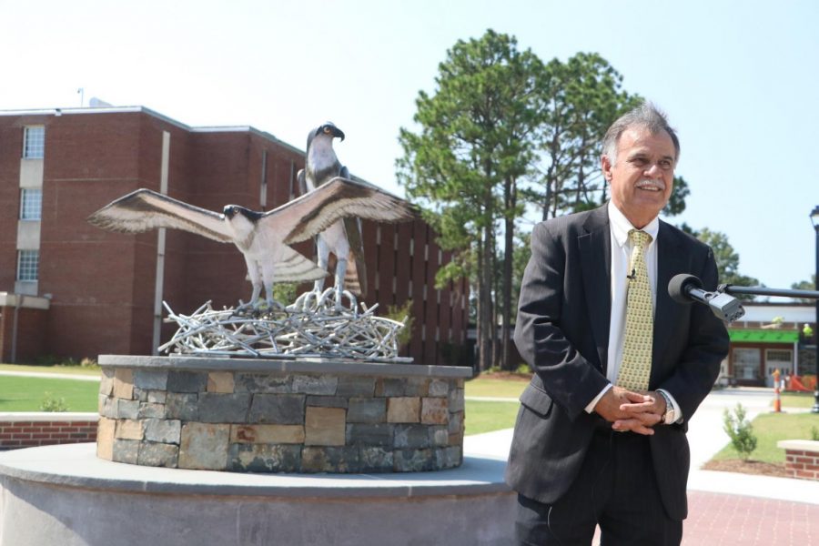 UNCW's Chancellor Jose V. Sartarelli in front of the new sculpture. 