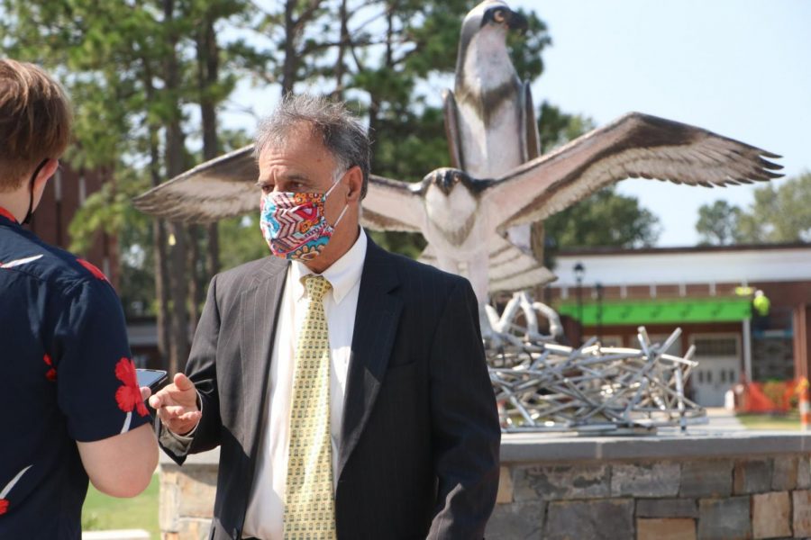 UNCW Chancellor Jose V. Sartarelli answering questions front of the new sculpture. 