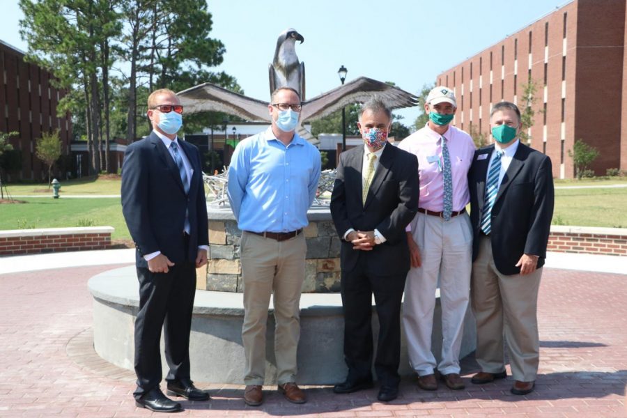 Associate Vice Chancellor for Business Affairs-Facilities Mark Morgan; Director of Housing and Residence Life Peter Groenendyk; Chancellor Jose V. Sartarelli;  Associate Vice Chancellor and Dean of Students Mike Walker; Interim Vice Chancellor for Student Affairs Brian Victor in front of the new sculpture. 