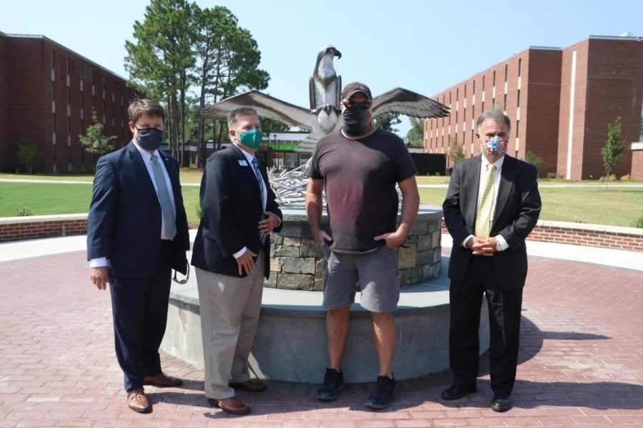 Vice Chancellor for University Advancement Eddie Stuart;  Interim Vice Chancellor for Student Affairs Brian Victor; the artist Dumay Gorham; Chancellor Jose V. Sartarelli in front of the new sculpture. 