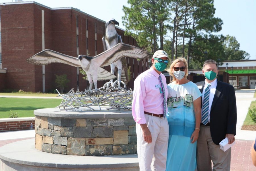  Associate Vice Chancellor and Dean of Students Mike Walker, Susan Vanecek, wife of the late Vice Chancellor for Student Affairs Pat Leonard, and Interim Vice Chancellor for Student Affairs Brian Victor  in front of the new sculpture. 