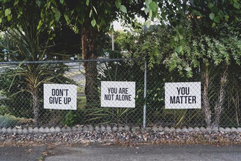 Signs posted on the fence of a 7-11 in Salem, Oregon.