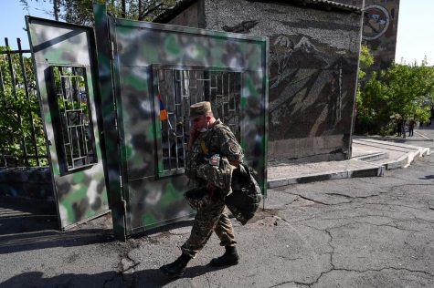 A man wearing a military uniform walks in front of a military commissariat in Yerevan on Spet. 30, 2020. Armenian Prime Minister Nikol Pashinyan on Wednesday said peace talks with Azerbaijan under Russian mediation would be inappropriate, as fighting over the breakaway Nagorny Karabakh region entered a fourth day. (AFP/Getty Images/TNS)