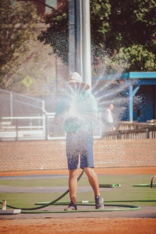 UNCW grounds crew getting the field ready for UNCW's scrimmage.