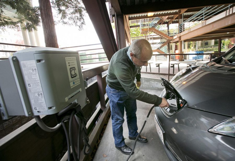 A Nissan Leaf electric car is charged at the City of Palo Alto EV charging station in the public garage in Palo Alto, California. 