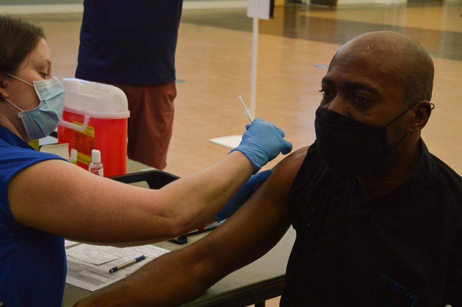 UNCW staff member recieves the Johnson & Johnson vaccine at the Burney Center clinic. 