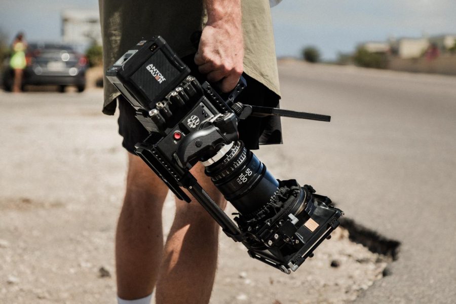 A man holds a film camera.