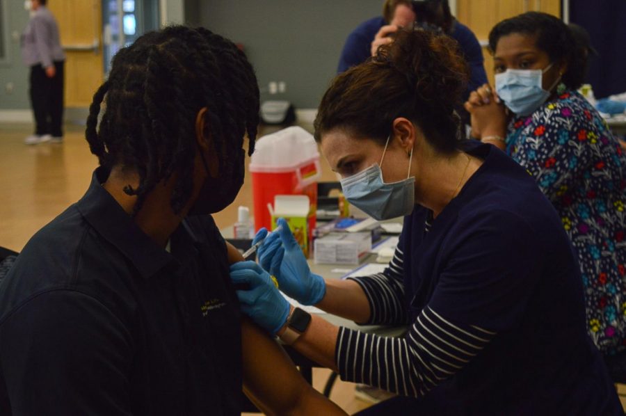 Administering the COVID-19 vaccine.