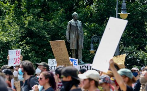 The Emmett Till statue is seen through protesters at the South Carolina State House in Columbia, South Carolina demonstrating their anger over racial injustice on June 5, 2020. 