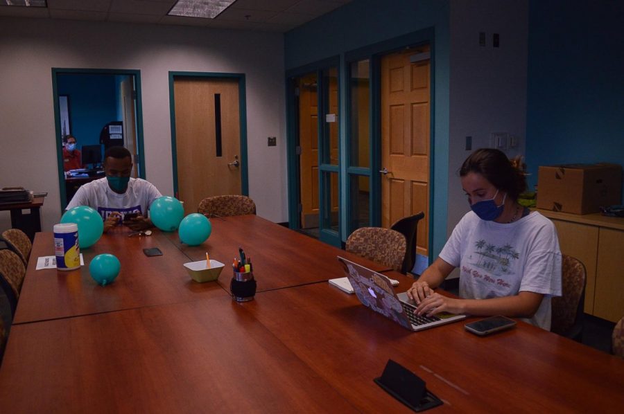 Students Boyce Rucker and Lauren Wessell working in the Student Media Center.