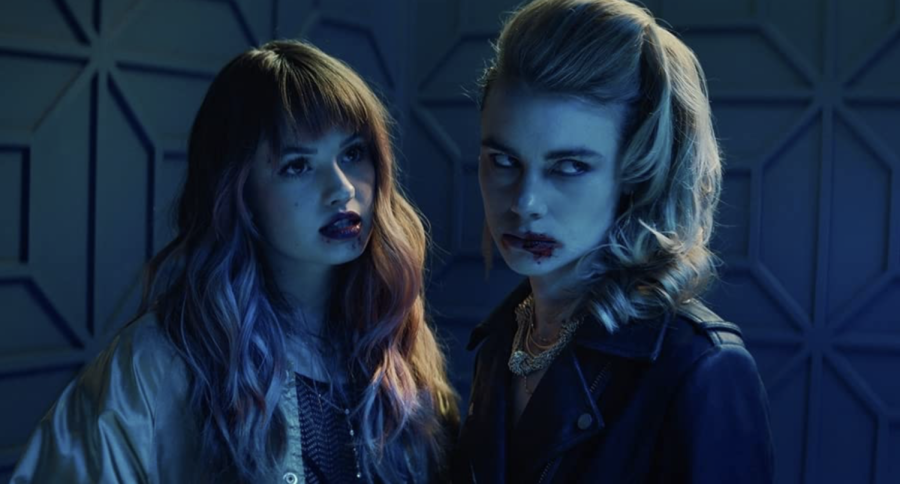 Debby Ryan and Lucy Fry in “Night Teeth” (2021).