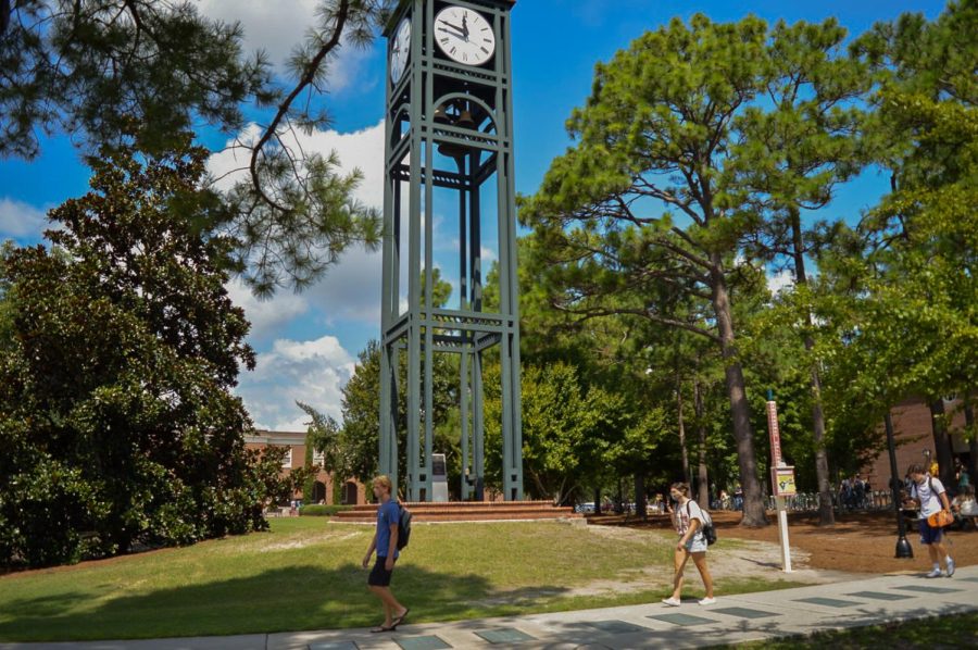 Students walk by the clocktower.