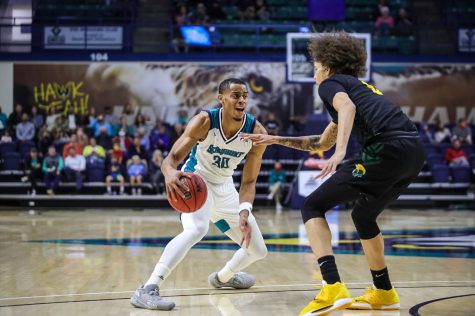 Jaylen Sims driving to the basket in UNCWs matchup with Norfolk State on Dec. 1, 2021 in Trask Coliseum (Davis Kirk).