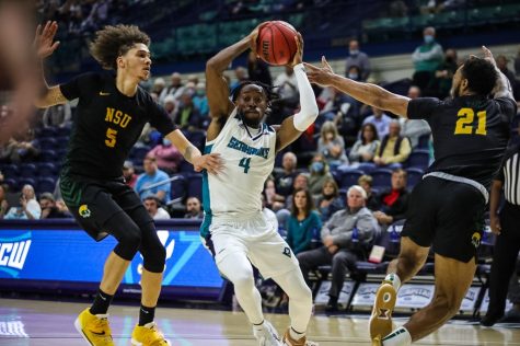 Mike Okauru driving to the basket in UNCWs matchup with Norfolk State on Dec. 1, 2021 inside Trask Coliseum (Davis Kirk)