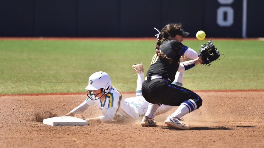 Taylor Vitola sliding into second base during UNCW’s matchup with Delaware on Mar. 27, 2022.