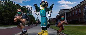 Sammy Seahawk and UNCW students demonstrating mask safety protocols in Spring of 2021.