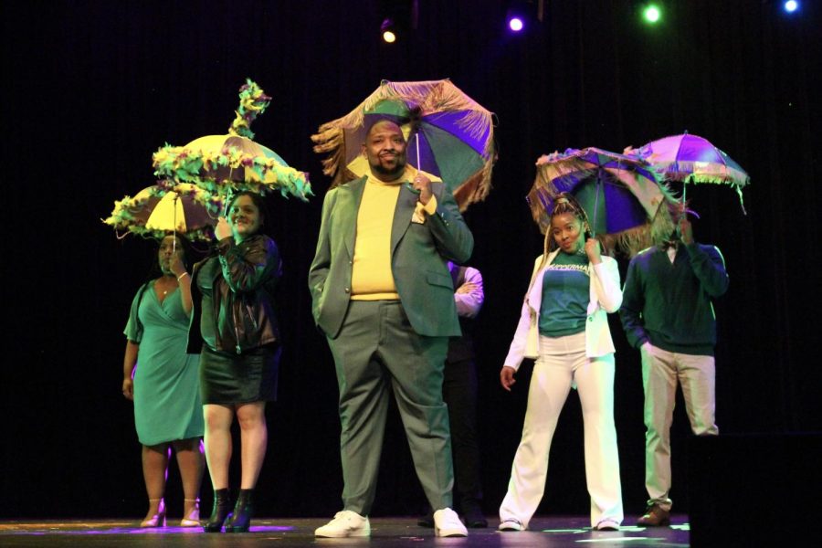 Students and faculty perform the finale of Upperman’s 5th annual Homecoming Fashion show. As they parade off stage, purple and gold tasseled umbrellas allude to next year's theme of Mardi Gras. (Nate Mauldin/The Seahawk)