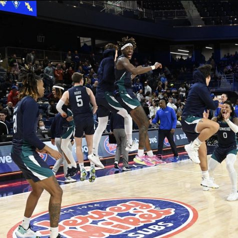Maleeck Harden-Hayes and the Seahawks celebrate after defeating Hofstra on Monday night. (Photo by CAASports via Instagram)
