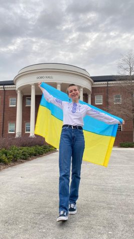 Olha Novikova poses with the Ukranian flag outside of Dobo Hall. Novikova is the current president of UNCWs Ukrainian Culture Club. (Courtesy of Olha Novikova)