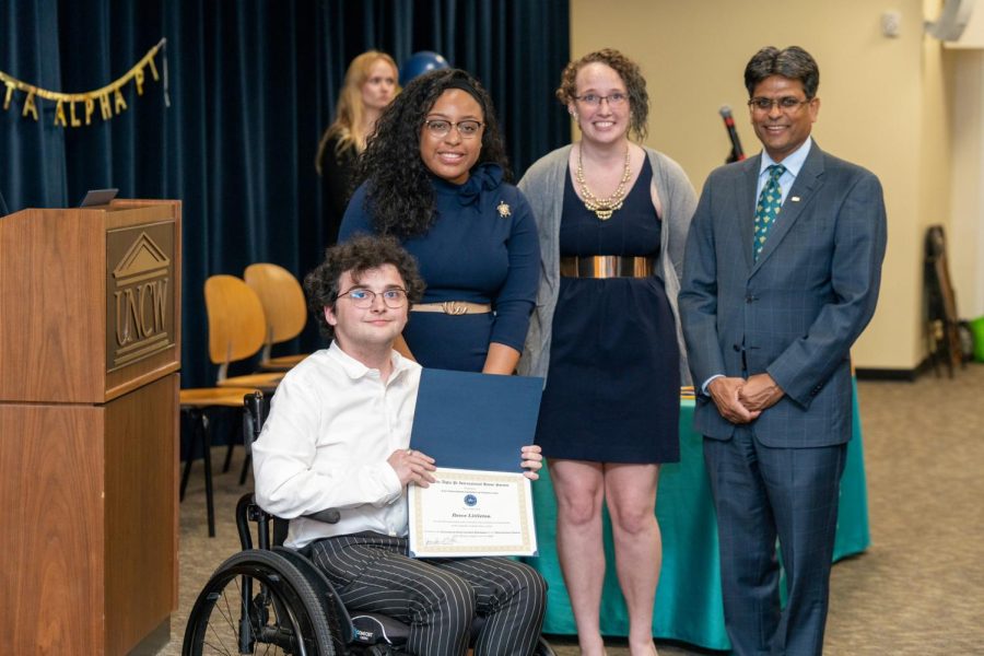 From left, Reece Littleton poses with Shayy Webb, Aurora Gregory and Chancellor Aswani Volety after being inducted into the Delta Alpha Pi Disability Honors Society. (Michael Spencer/UNCW)