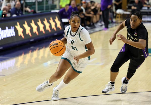 Kylah Silver dribbles past her defender towards the basket (UNCW Athletic Department)