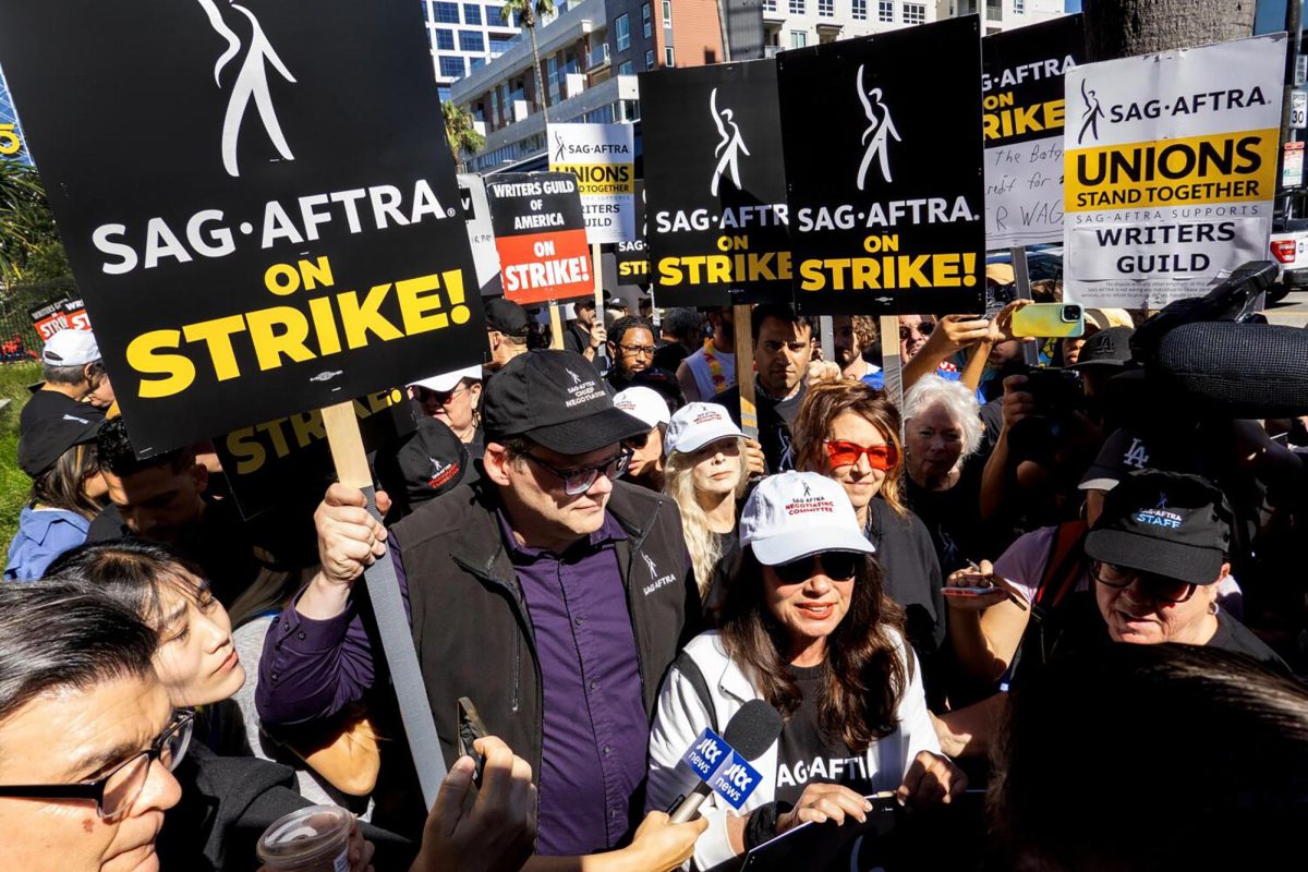 SAG-AFTRA President Fran Drescher, white cap front, and National Executive Director and Chief Negotiator Duncan Crabtree-Ireland, left, greet picketers at the Netflix picket line in Los Angeles, on July 14, 2023. (Myung J. Chun/Los Angeles Times/TNS)