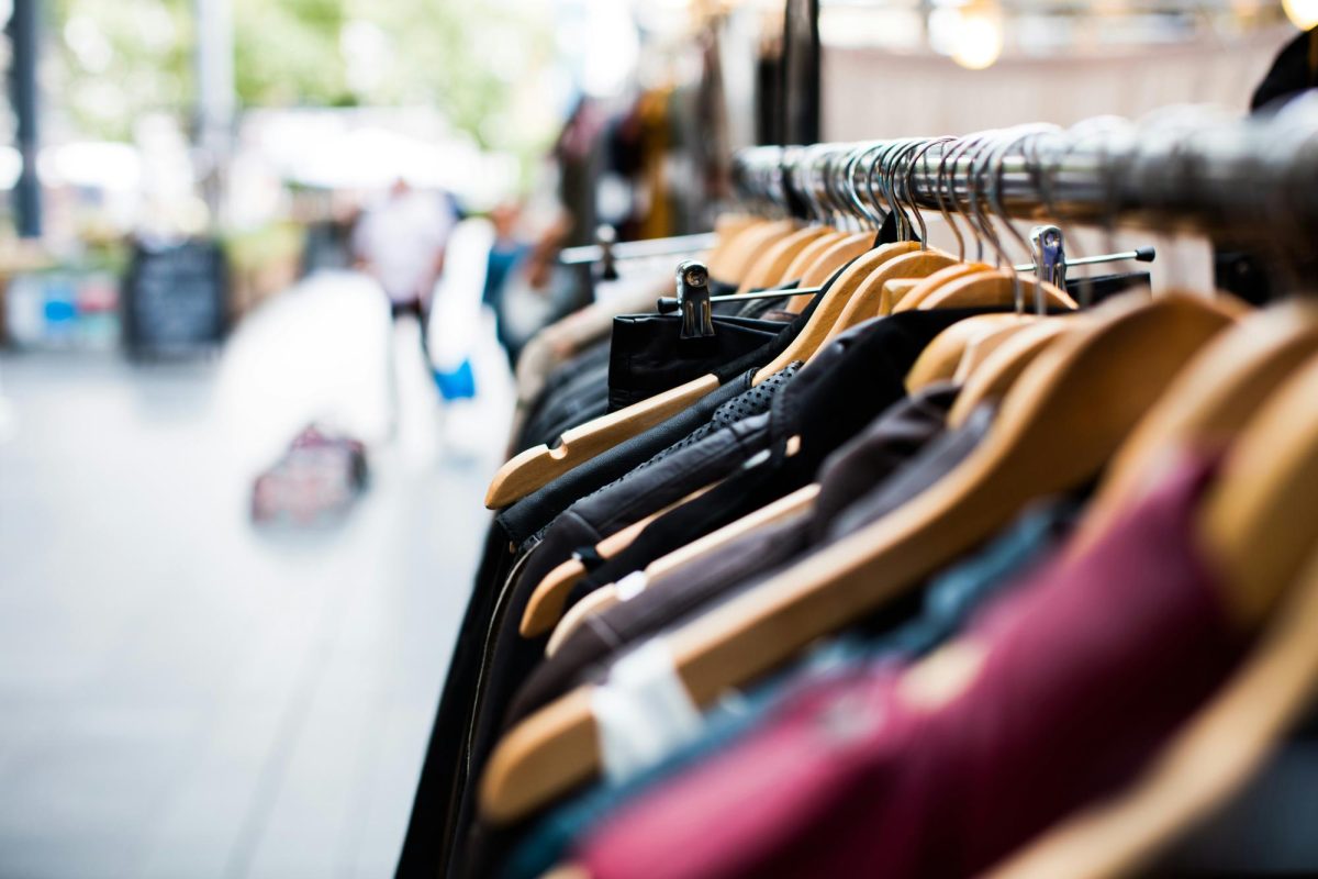 Clothes on hangers outside of a store. (Artificial Photography/Unsplash.com)