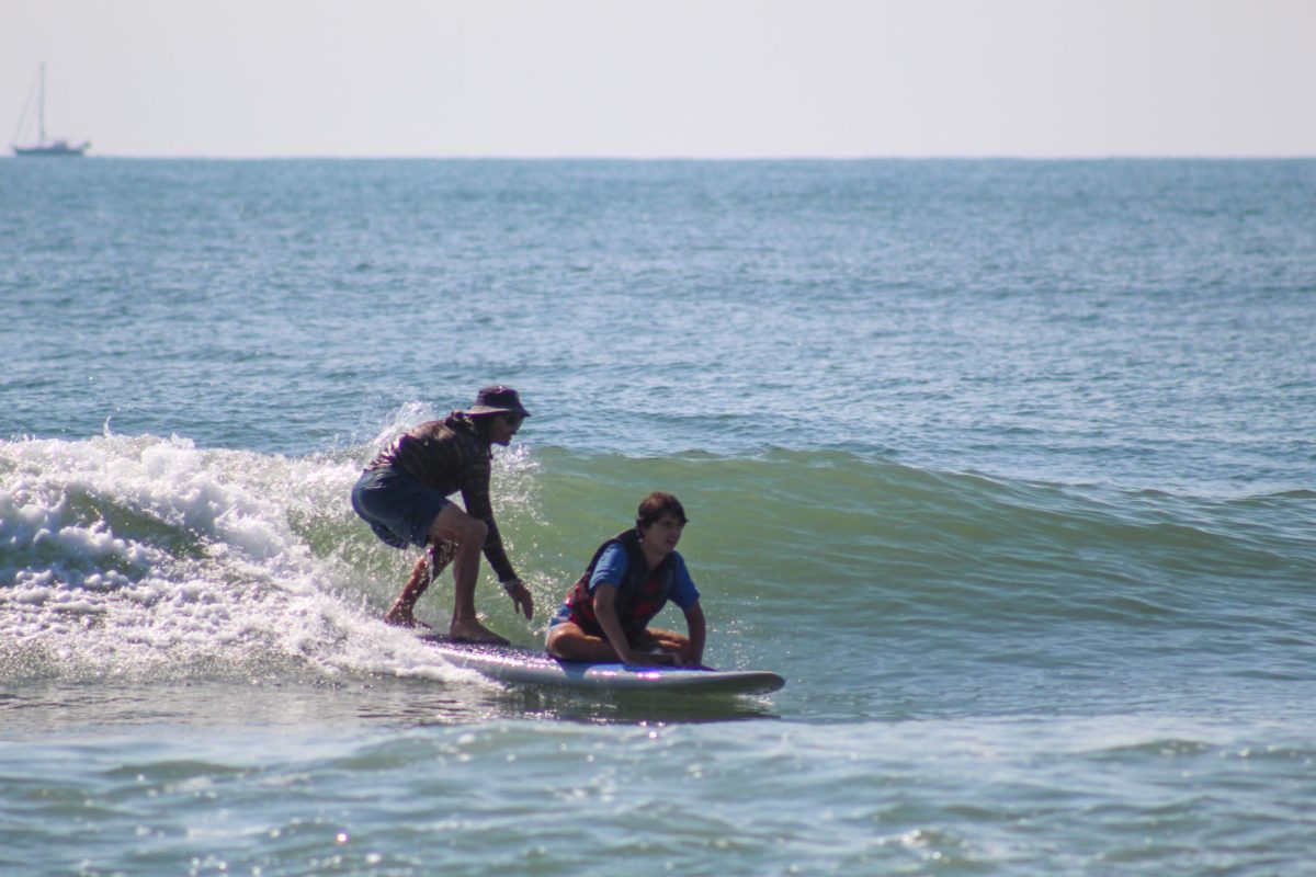 Liam surfing at this year's Surfer's Healing event. (Aidyn Fischli/The Seahawk)