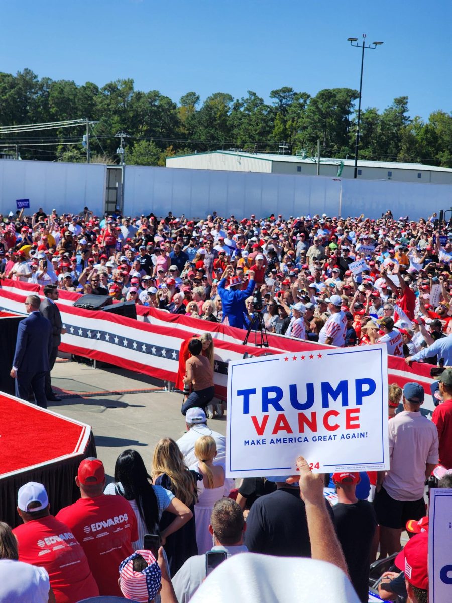 Trump supporter holding up a Trump and Vance sign at the Wilmington International Airport (Jamie Leigh/The Seahawk)