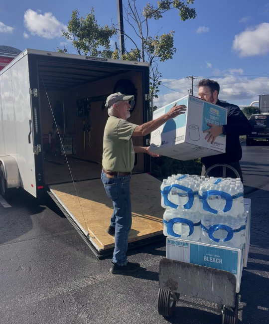  Randy Newton is joined by local business employee Christian Staley in loading Newton’s trailer with donations to prepare for a drive across the state. (Bridget Flanagan/The Seahawk)