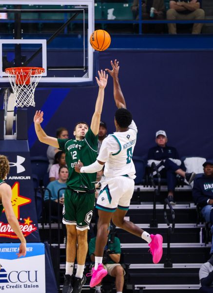 Bo Montgomery, number 0, shooting the ball in the net (Brayden Green/The Seahawk/@blurry_wave.photo)