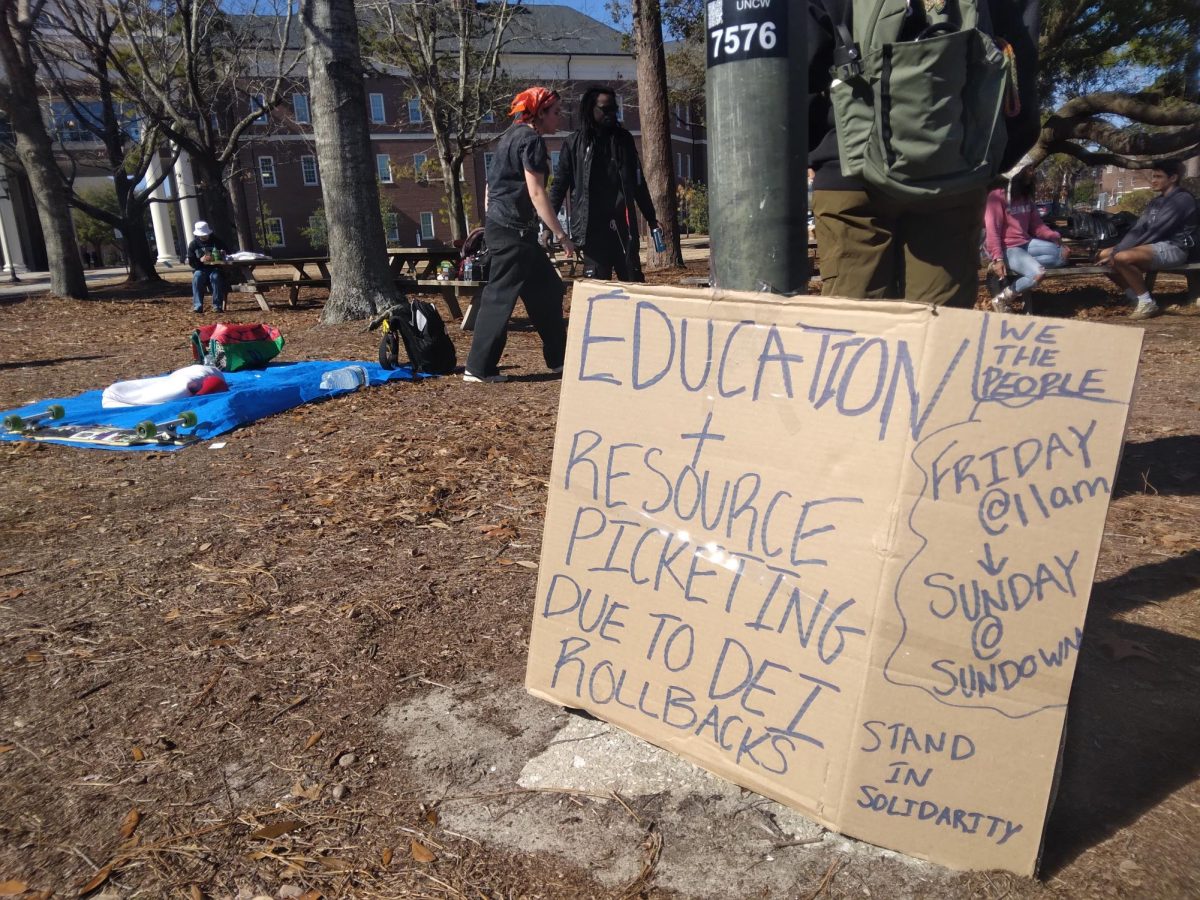 Education and resource picketing sign in front of the @lovenothateuncw group. (Megan Eesley/The Seahawk). 