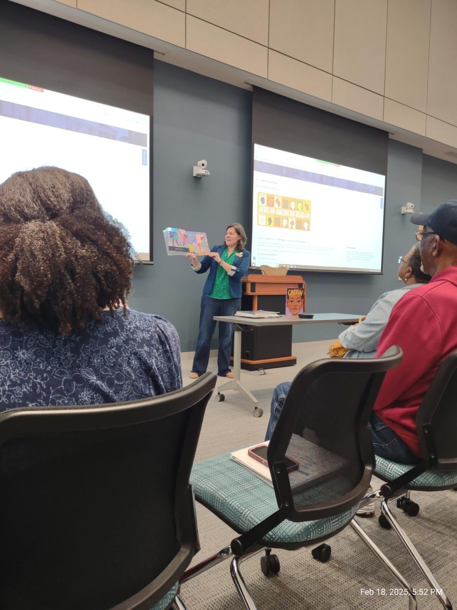 Dr. Caitlin Ryan, UNCW professor at Watson College of Education, reading "Saturday" (Deborah Williams/The Seahawk).