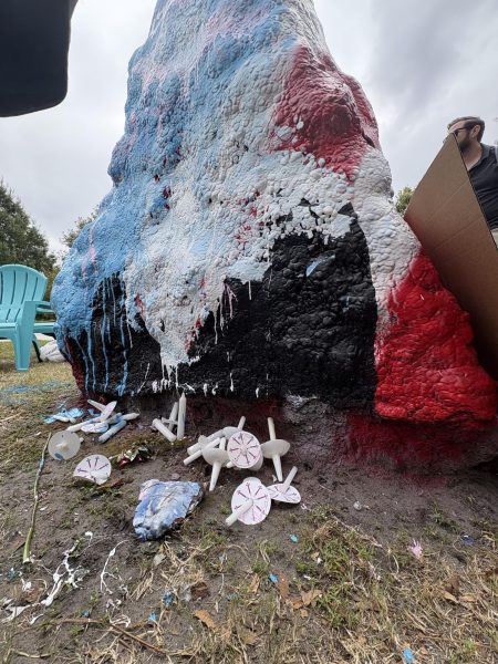Overturned candles sit below spirit rock, after student scabble (Addison Lowry/The Seahawk).