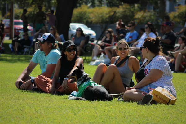 A group of viewers sits together, one sporting a jersey alongside her dog (Max Matthews/The Seahawk).